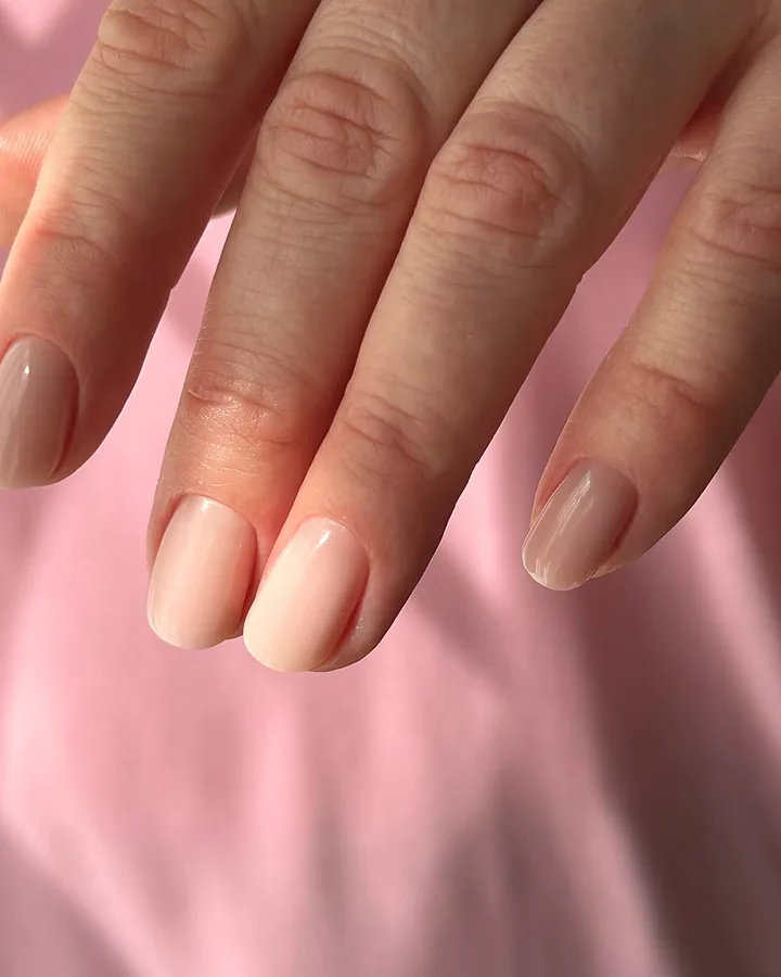 Short oval nails in a soft nude gel after a Russian manicure