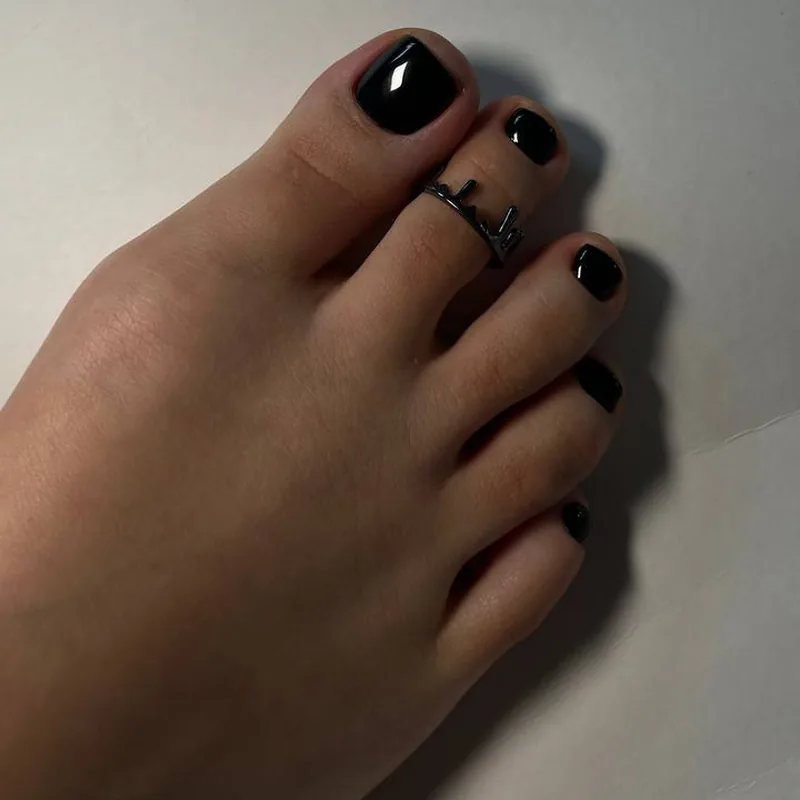 A glossy black gel pedicure